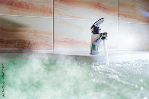 Water Tap Pouring Hot Water In A Bath Tub With Steam Stock Photo Adobe Stock