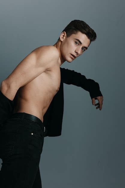Premium Photo A Man In A Dark Jacket Nude Torso Gray Background Closeup High Quality Photo