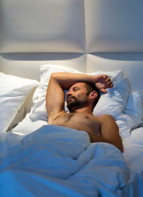 Premium Photo Sleepy Bearded Man Lying In Bed On His Back Under A White Blanket Sleeping Naked