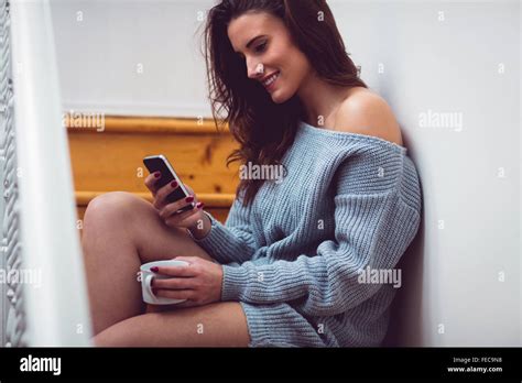 Beautiful Brunette Sitting On Stairs Using Her Smartphone Stock Photo Alamy
