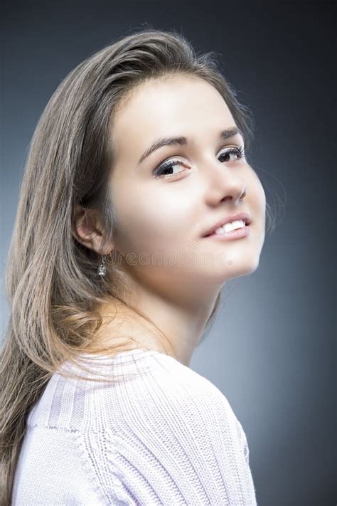 Portrait Of Sensual And Shy Positive Caucasian Brunette With Natural Long Hair Posing In Sweater