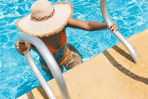 Woman In Sun Hat And Bikini Getting Out Of Sunny Summer Swimming Pool Stock Photo Image Of