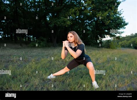 Athletic Blonde Doing Squats With Stretching Legs To The Side Stock Photo Alamy