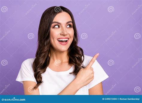 Photo Of Impressed Brunette Millennial Lady Look Point Empty Space Wear White T Shirt Isolated