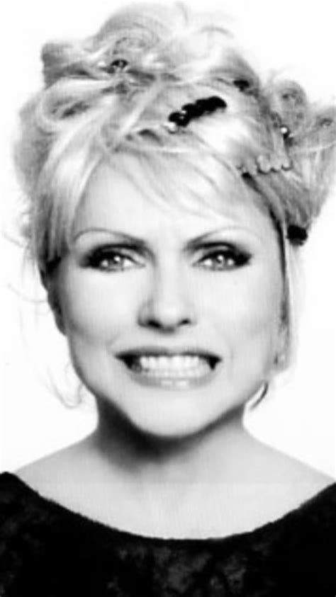 A Black And White Photo Of A Woman With Blonde Hair In A Bun Hairstyle