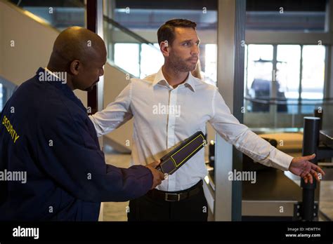 Security Guard Frisking A Passenger At Airport Terminal Stock Photo Alamy