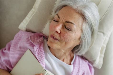 Top View Of Beautiful Mature Woman Asleep With Book Weekend Activity For Older Woman Relaxing