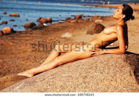 Naked Woman Sitting On Stone Beach Stock Photo Shutterstock