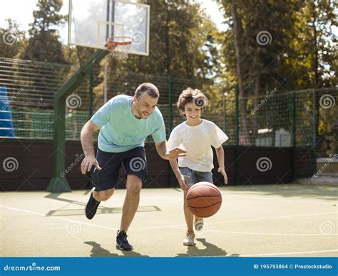 Mature Dad Teaching His Son How To Play Basketball Stock Photo Image