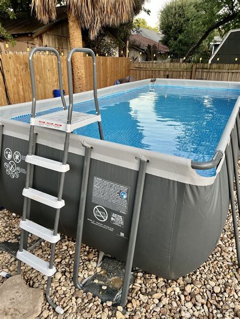 An Above Ground Swimming Pool With Ladders