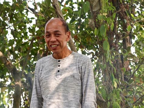 Premium Photo Portrait Of Smiling Man Standing Against Plants