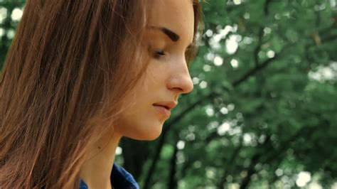 Beautiful Brunette With Long Hair Stands On The Street And Puts On Glasses Stock Video