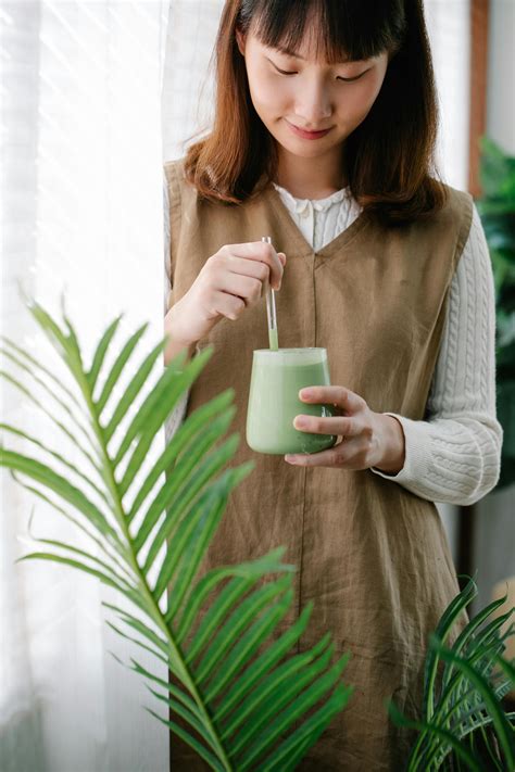 Woman Drinking Matcha From Glass · Free Stock Photo