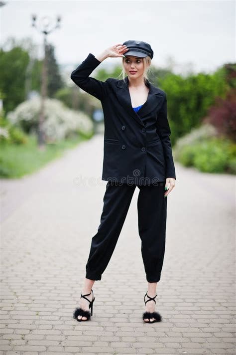 Portrait Of Beautiful Blonde Fashion Woman Model In Cap And In All Black With Bright Makeup