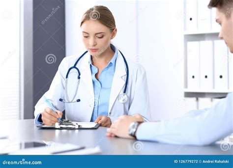Doctor And Patient In Hospital Beautiful Blonde Physician Consulting Business Man About His