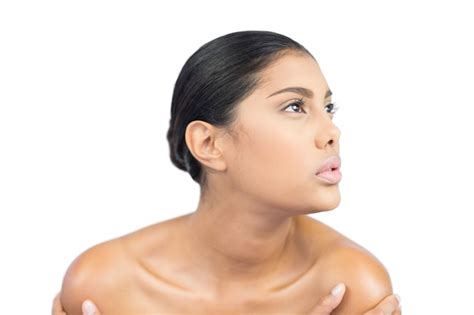 Premium Photo Unsmiling Nude Brunette Holding Shoulders Looking Up