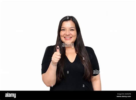 Latina Adult Woman Excitedly Shows Her Inked Thumb After Exercising Her Free And Secret Vote In