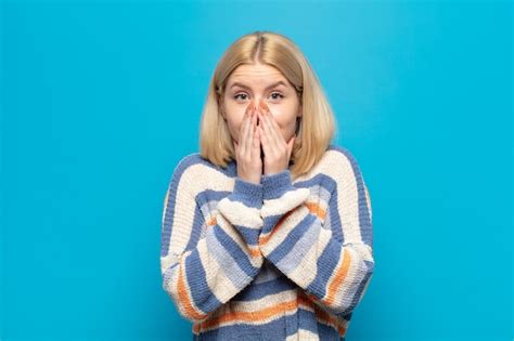 Premium Photo Blonde Woman Happy And Excited Surprised And Amazed Covering Mouth With Hands