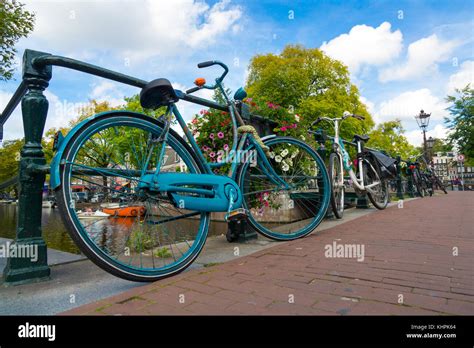 Traditional Dutch Bicycle Parked On Canal In Amsterdam Stock Photo Alamy