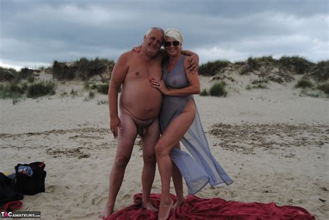 Older Platinum Blonde Dimonty Blows A Kiss While At A Nude Beach With Her Man CoedCherry