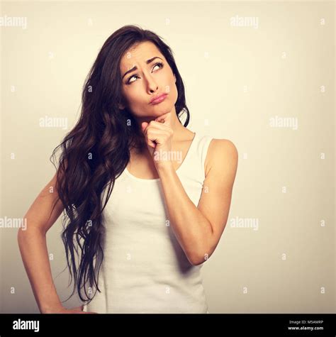 Confusion Grimacing Brunette Woman Thinking And Looking Up In White T Shirt On Empty Copy Space