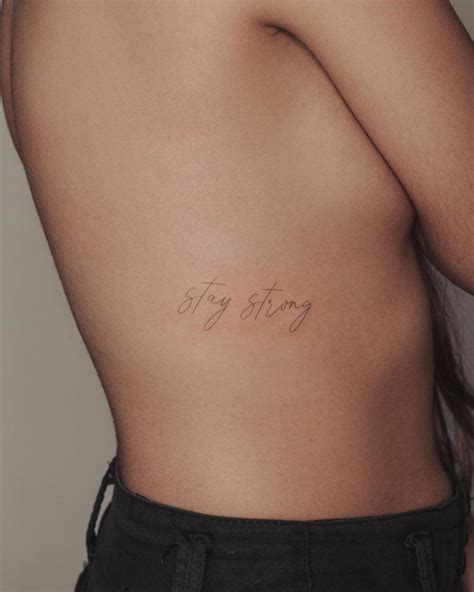 Stay Strong Lettering Tattoo On The Rib