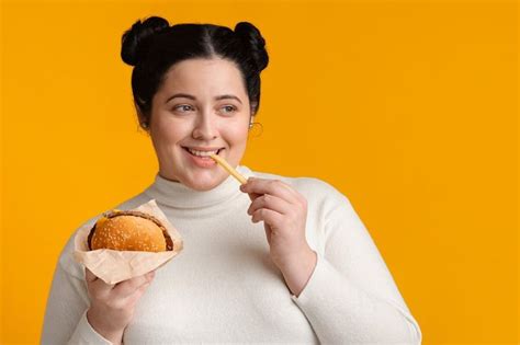 Brunette Plump Girl Eating Hamburger