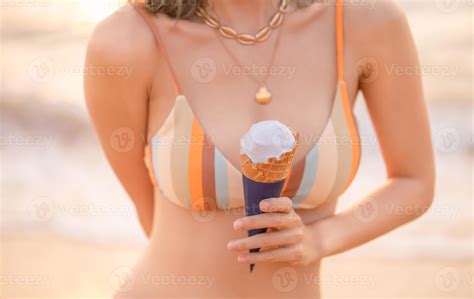Portrait Of Woman Wearing Bikini On The Beach Eating Ice Cream Golden Sunset Moment Holiday