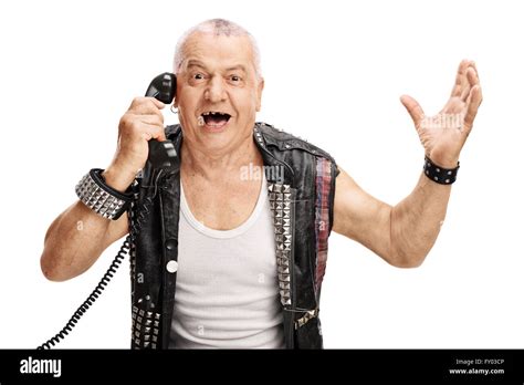 Mature Man In An Old Punk Jacket Talking On Telephone And Gesturing