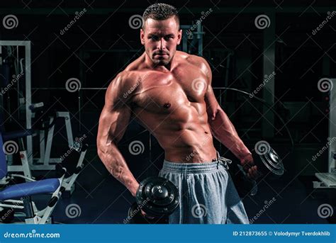 Sportsman With Naked Torso Maintaining Healthy Lifestyle Standing Leaning On Trainer Holding