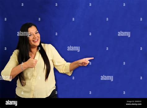 Year Old Latina Woman Points With The Fingers Of Her Hand To Something That She Likes