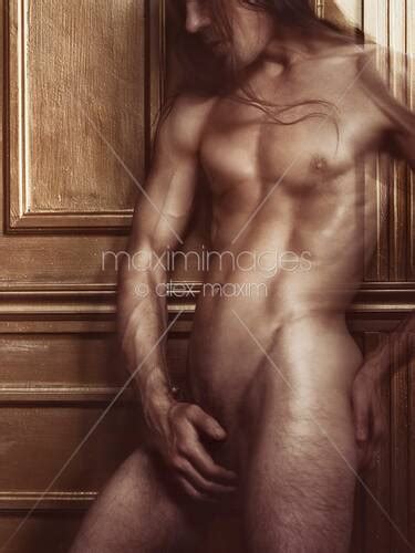 Photo Of Dramatic Art Nude Portrait Of Nude Man With Shiny Muscular Body Leaning Against Golden