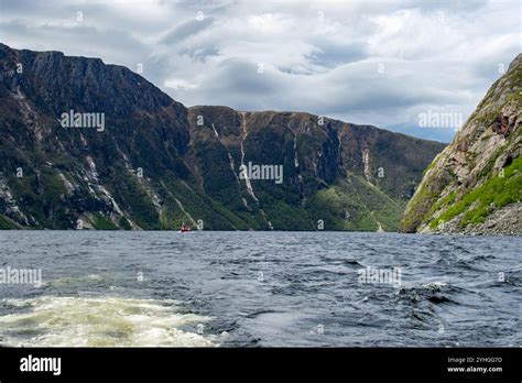 Fishing boat navigates rocky hi-res stock photography and images - Alamy