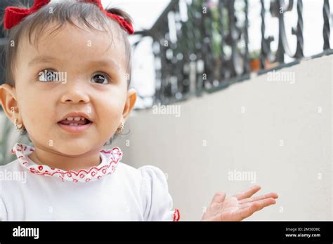 Beautiful Brunette Baby With A Face Of Happiness And Surprise Opening