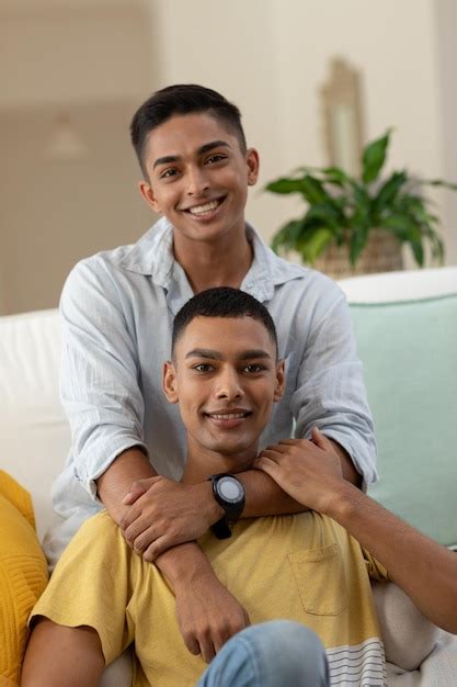 Premium Photo Portrait Of Diverse Gay Male Couple Sitting On Sofa Looking At Camera And Smiling