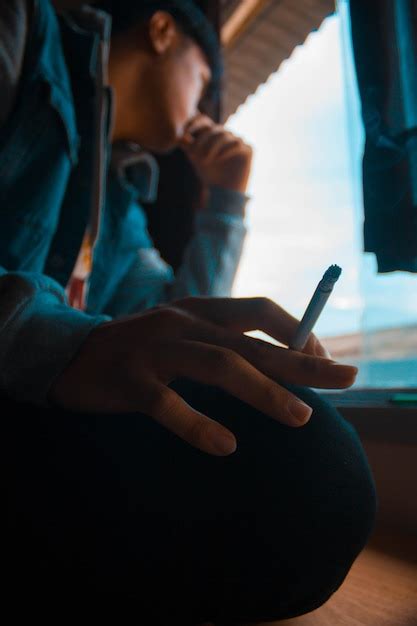 Premium Photo Close Up Of Man Holding Cigarette