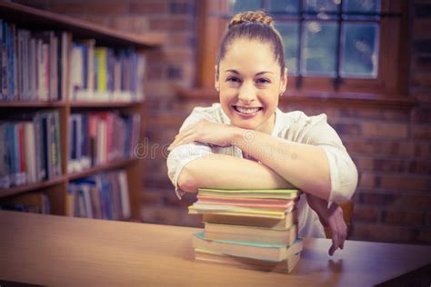 Blonde Teacher Leaning On Pile Of Books In The Library Stock Photo Image Of Library Librarian