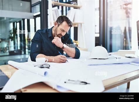 Working Hard To Meet His Clients Needs A Mature Male Architect Working