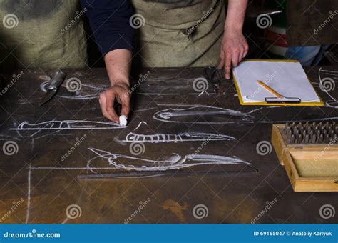 Table In A Forge Planning Design Of Knife Craftsman Stands Near The