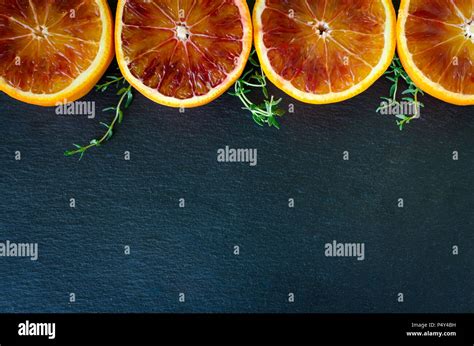 Raw Of Sliced Blood Oranges With Thyme Citrus Background Texture Cut