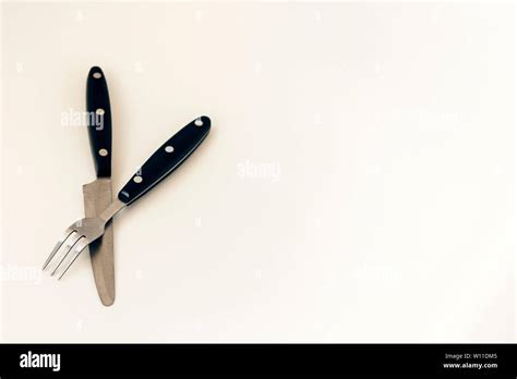 Close Up Knife And Fork Crossed Isolated On White Background Stock