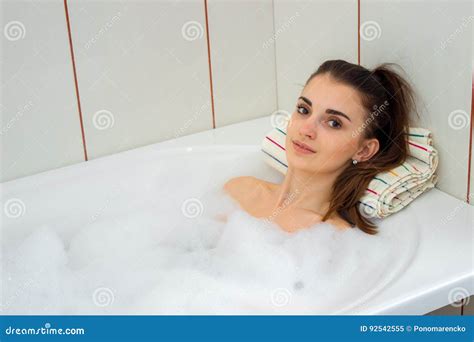 Cute Brunette Lies In The Bath With Foam And Looks Into The Camera Stock Image Image Of People