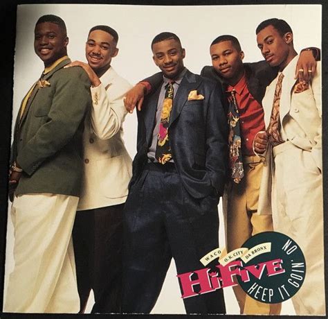 Four Men In Suits And Ties Posing For The Camera With Their Arms Around