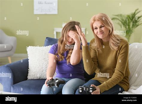 Mature Woman And Her Cute Granddaughter Playing Video Game At Home Stock Photo Alamy