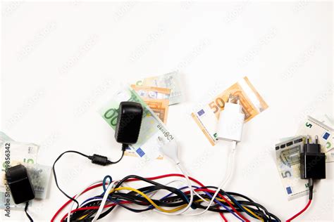 Electric power wires cables cords with Euro banknotes on white ...