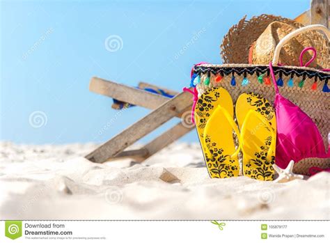 Summer Travel Bikini And Flip Flops Hat Fish Star And Bag Near Beach Chair On Sandy Beach