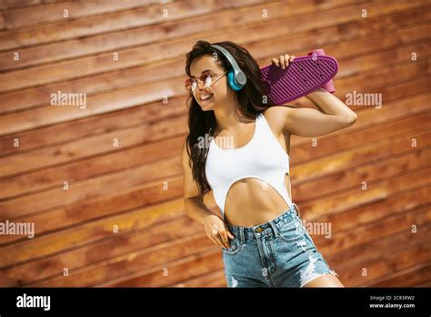 Beautiful Brunette Girl With Skateboard Feeling Amazing Stock Photo Alamy