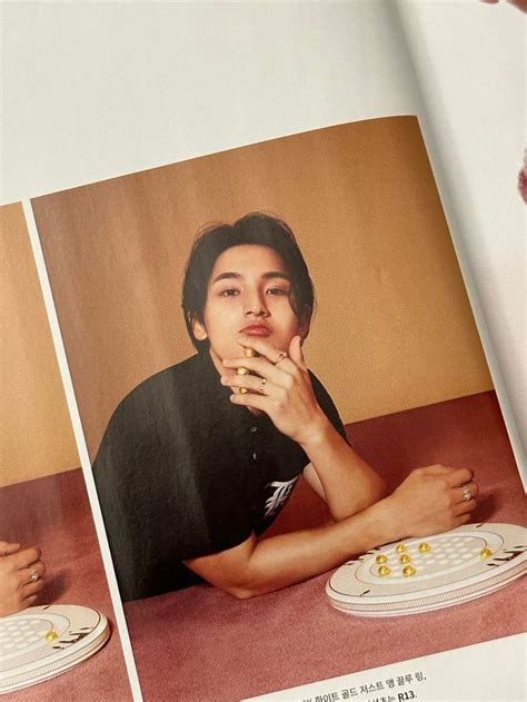 An Open Magazine With Two Pictures Of A Man Sitting At A Table And One