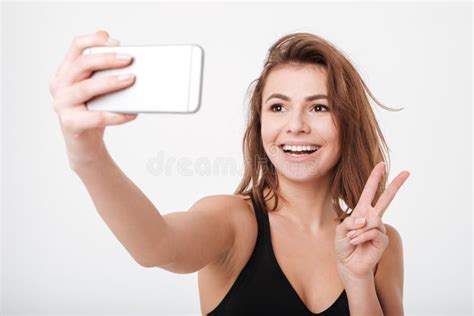 Cheerful Young Fitness Woman Make A Selfie With Peace Gesture Stock