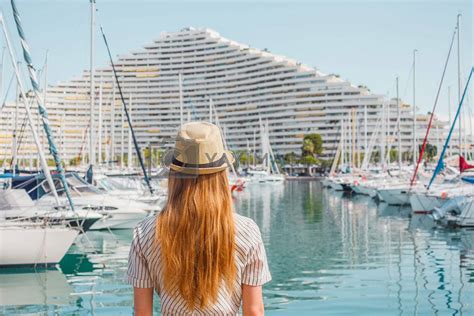 Blonde Hair Woman In A Hat Standing With Her Back On Sea Yachts And Boats Background Nice